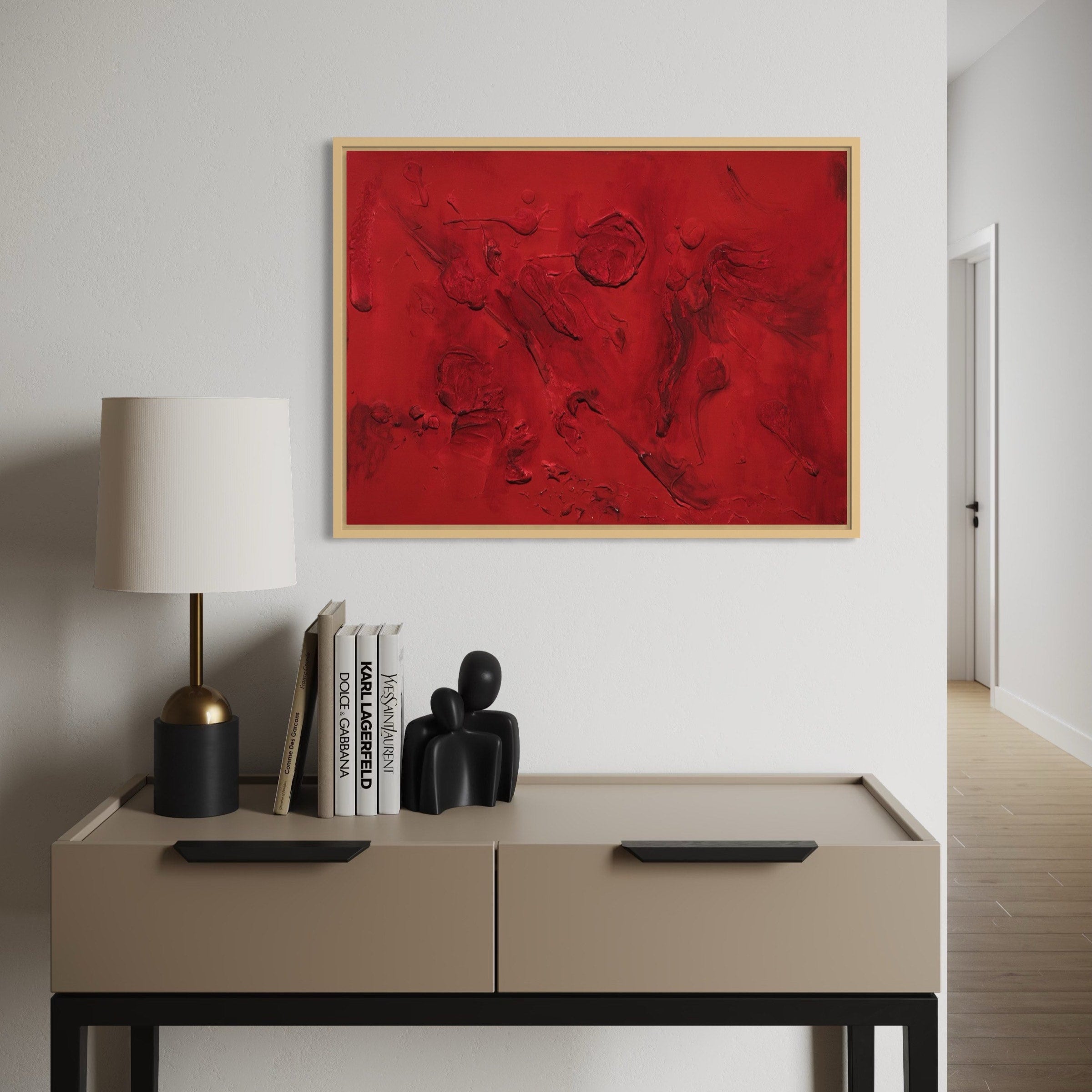 Modern interior with a beige desk, red abstract painting, and decorative items.